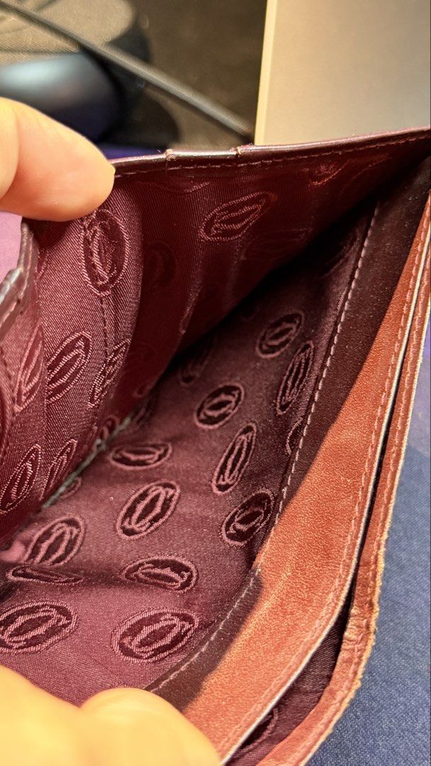 Cartier Leather Wallet (Category: Luxury Bags & Wallets) located in Capas. Submitted by silvertiger_130b66 (Listing ID 1421800334, Image 3). Description: - Cartier burgundy leather wallet - Embossed Cartier logo - Multiple card slots - Bill compartment - Repeating Cartier logo lining - Gold-colored corner accents.