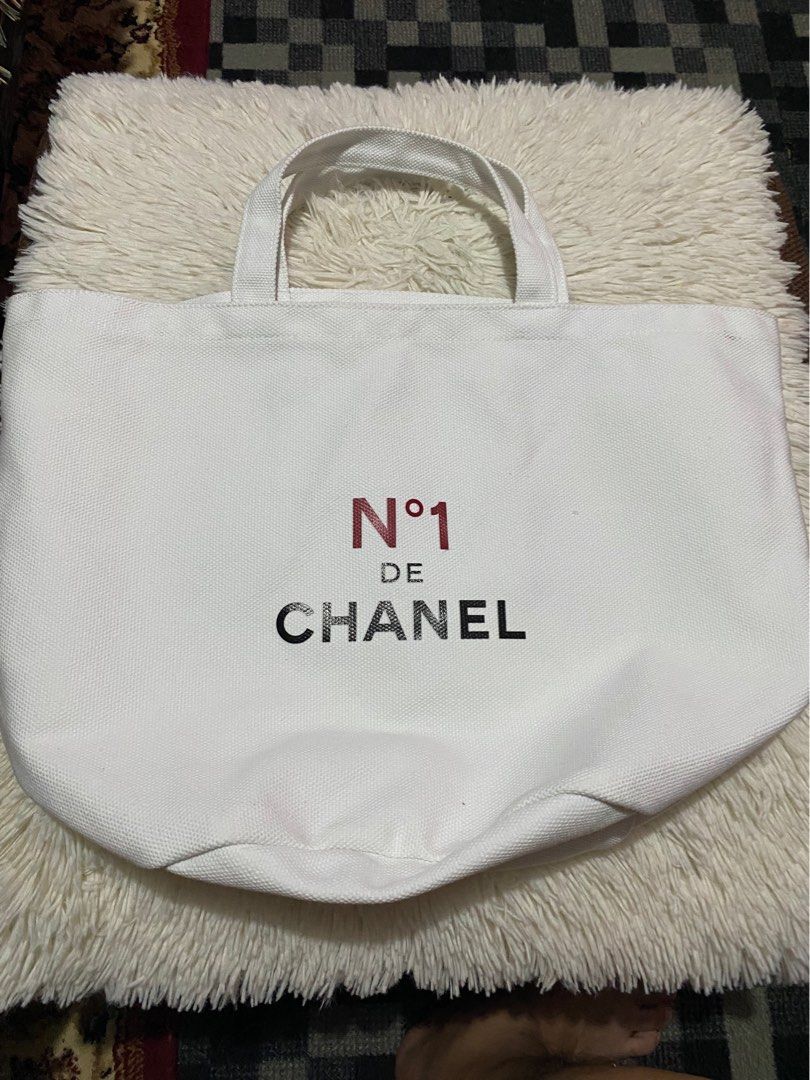 Chanel No. 1 De Chanel Tote Bag (Category: Luxury Bags & Wallets) located in Bulacan. Submitted by rich2545 (Listing ID 1421877128, Image 3). Description: - Chanel No. 1 De Chanel tote bag - Features the Chanel logo - Floral design on the other side - Made of canvas-like material - Two handles for carrying.