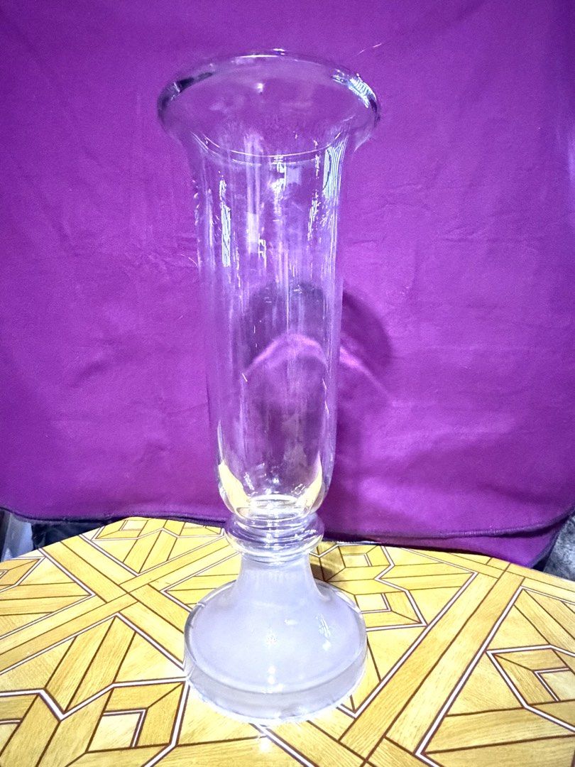 Clear Glass Vase (Category: Vases & Decorative Bowls) located in Dasmarinas. Submitted by andrae03 (Listing ID 1421877020, Image 1). Description: Elegant glass vase. Features a flared top and frosted base. — 18inches tall, 7 inches diameter. Perfect for flowers or decor. — have dents, as you can see sa pic.