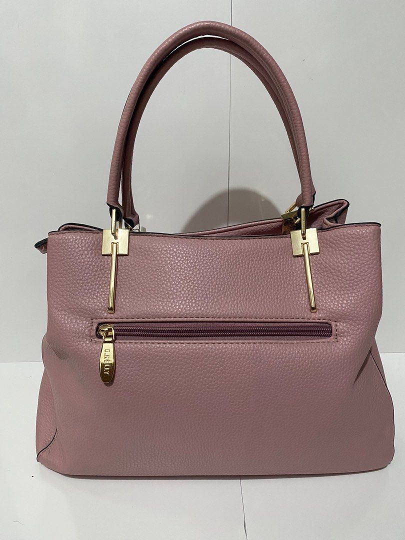 D. Kelly Japan Handbag (Category: Luxury Bags & Wallets) located in Manila. Submitted by tmyjapanfinds2022 (Listing ID 1421904692, Image 3). Description: - Brand: D. Kelly Japan - Color: Pink - Features: Bow detail, two handles, detachable flower charm - Compartments: Zippered main compartment, inner zippered pocket - Condition: Good.
