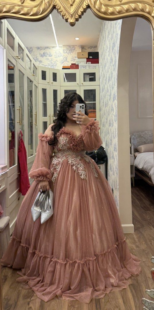 Dusty Rose Off-Shoulder Ball Gown (Category: Evening dresses & gowns) located in Manila. Submitted by yedja (Listing ID 1421859037, Image 2). Description: - Elegant dusty rose ball gown - Off-shoulder design - Sweetheart neckline with floral detailing - Long, sheer sleeves - Full, layered skirt with ruffled hem - Includes matching silver heels - Perfect for special occasions.