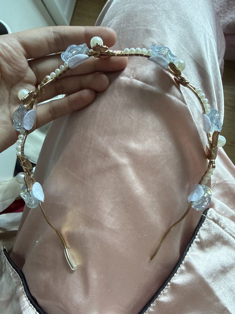 Floral Headband with Blue Roses (Category: Hair Accessories) located in Manila. Submitted by asprelovedcni (Listing ID 1421823067, Image 3). Description: - Features delicate blue rose accents, pearls, and gold-toned leaves. - Design includes a series of blue roses and pearls. - Flexible wire frame for comfortable wear. - Ideal for special occasions or adding a touch of whimsy. - Used once.