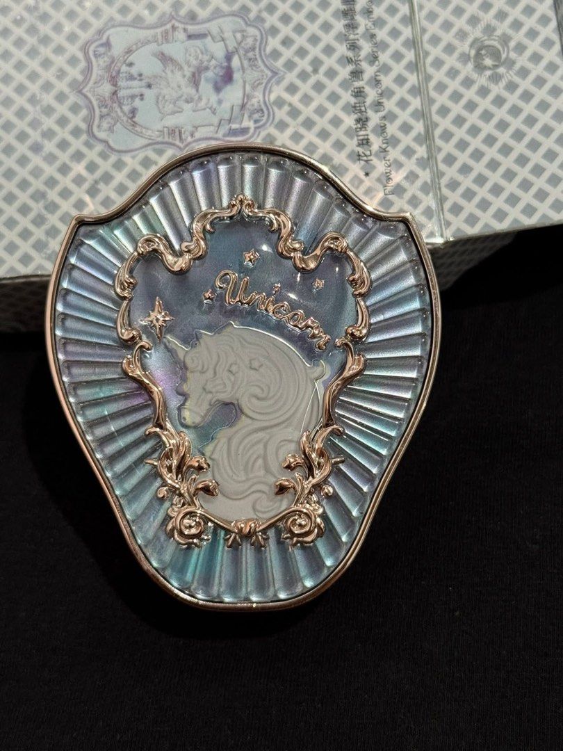 Flower Knows Unicorn Blush (Category: Makeup) located in Manila. Submitted by n4thlie (Listing ID 1421914489, Image 1). Description: Flower Knows blush features a beautiful, ornate compact with a unicorn design. The blush itself is a soft pink shade, embossed with a detailed design. The compact has a mirror inside. The packaging has a light blue and white pattern..