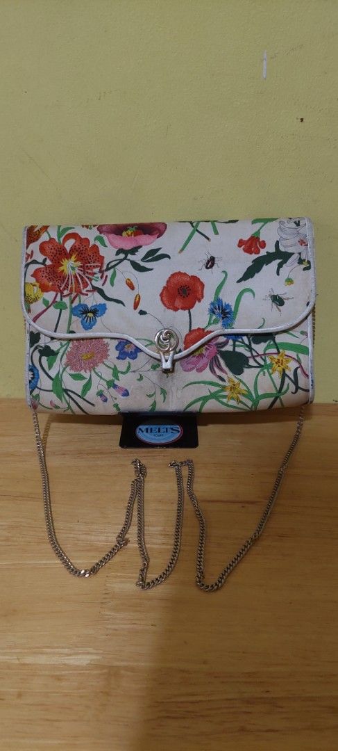 Gucci Floral Print Clutch with Chain Strap (Category: Clutches) located in Manila. Submitted by aabila (Listing ID 1421903705, Image 1). Description: - Floral print clutch - Includes silver chain strap - Clasp closure - Compact size - Features a vibrant floral design Authentic and vintage .