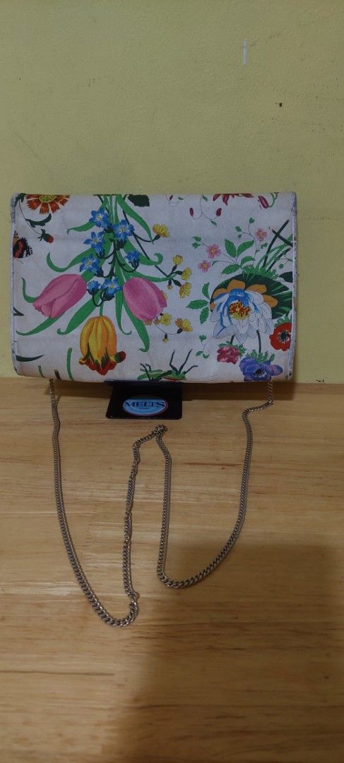 Gucci Floral Print Clutch with Chain Strap (Category: Clutches) located in Manila. Submitted by aabila (Listing ID 1421903705, Image 2). Description: - Floral print clutch - Includes silver chain strap - Clasp closure - Compact size - Features a vibrant floral design Authentic and vintage .