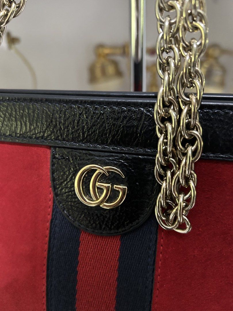 Gucci Sylvie 1969 Mini Bag (Category: Luxury Bags & Wallets) located in Manila. Submitted by mariantim76369 (Listing ID 1421837232, Image 2). Description: - Authentic Gucci Sylvie 1969 Mini Bag - Red suede body with black leather trim - Gold-tone chain strap - Iconic GG logo - Light blue fabric interior lining - Includes serial number tag - Approximately 10 inches in length.