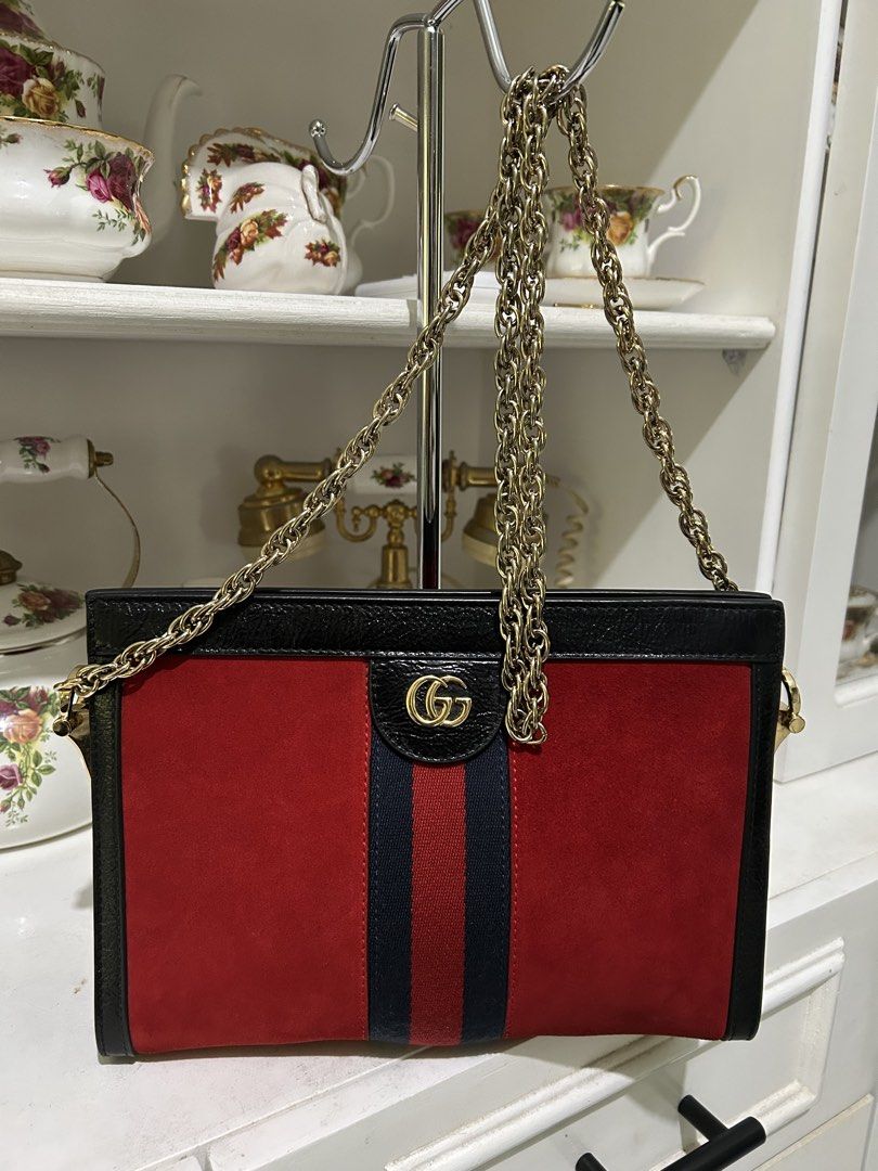 Gucci Sylvie 1969 Mini Bag (Category: Luxury Bags & Wallets) located in Manila. Submitted by mariantim76369 (Listing ID 1421837232, Image 1). Description: - Authentic Gucci Sylvie 1969 Mini Bag - Red suede body with black leather trim - Gold-tone chain strap - Iconic GG logo - Light blue fabric interior lining - Includes serial number tag - Approximately 10 inches in length.