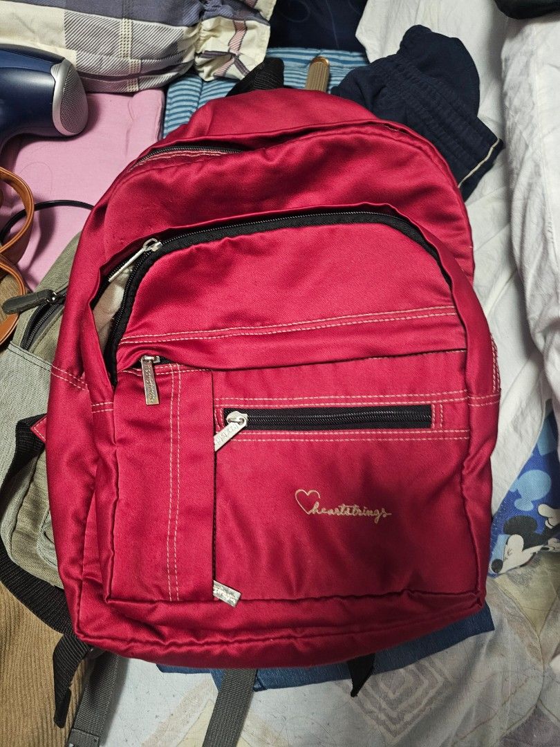 Heartstrings Red Backpack (Category: Backpacks) located in Antipolo. Submitted by 1ceb3rg (Listing ID 1421821448, Image 3). Description: - Red Heartstrings backpack - Multiple zippered compartments for storage - Adjustable shoulder straps - Top handle - Durable, possibly water-resistant material - Classic design, perfect for everyday use.