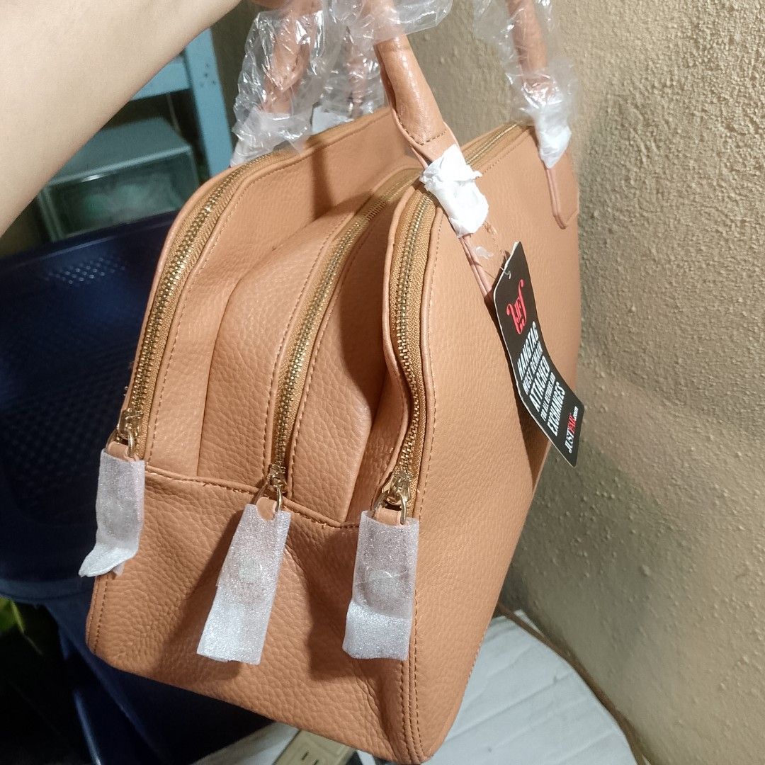 Handbag (Category: Shoulder Bags) located in Santa Maria. Submitted by avvvs (Listing ID 1421833067, Image 3). Description: - Tan handbag from Just Fab - Double zipper design - Gold-toned hardware - Striped interior lining - Interior zippered pocket - Includes hangtag (required for returns/exchanges) - Handles wrapped in plastic.