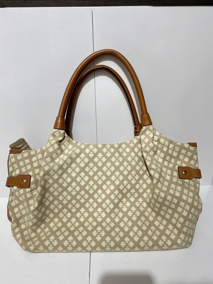 Kate Spade Handbag (Category: Luxury Bags & Wallets) located in Manila. Submitted by tmyjapanfinds2022 (Listing ID 1421904278, Image 3). Description: - Kate Spade handbag - Beige patterned exterior - Brown leather handles - Red and pink stripe detail - Kate Spade logo - Kate Spade logo lining - Multiple zippered compartments.