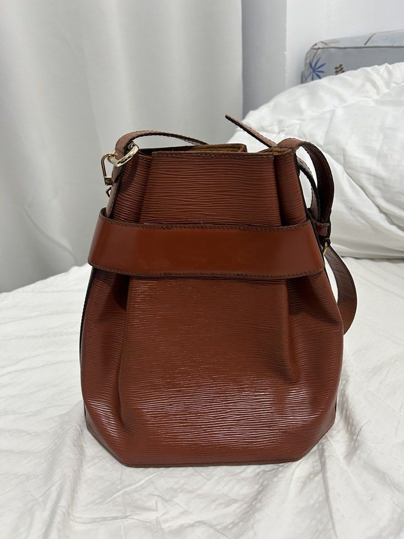 Louis Vuitton Epi Leather Bucket Bag (Category: Luxury Bags & Wallets) located in Quezon City. Submitted by bambibearnut (Listing ID 1421900812, Image 2). Description: - Authentic Louis Vuitton bucket bag - Epi Leather in brown color - Structured design - charm not included - Signature Epi leather texture Flaw - with leather cracks thus selling low.