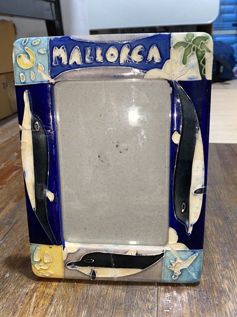 Mallorca Souvenir Frame (Category: Frames & Pictures) located in Makati City. Submitted by lasthing.22 (Listing ID 1421924496, Image 3). Description: - Mallorca souvenir frame. - Features a vibrant blue and white ceramic design. - Adorned with dolphin motifs. - Ideal for displaying photos. - A unique piece for your home. - Meetup locations available in Makati City. RFS: Declutter MOP: Gcash/Bank Transfer MOD: J&T/Lalamove.