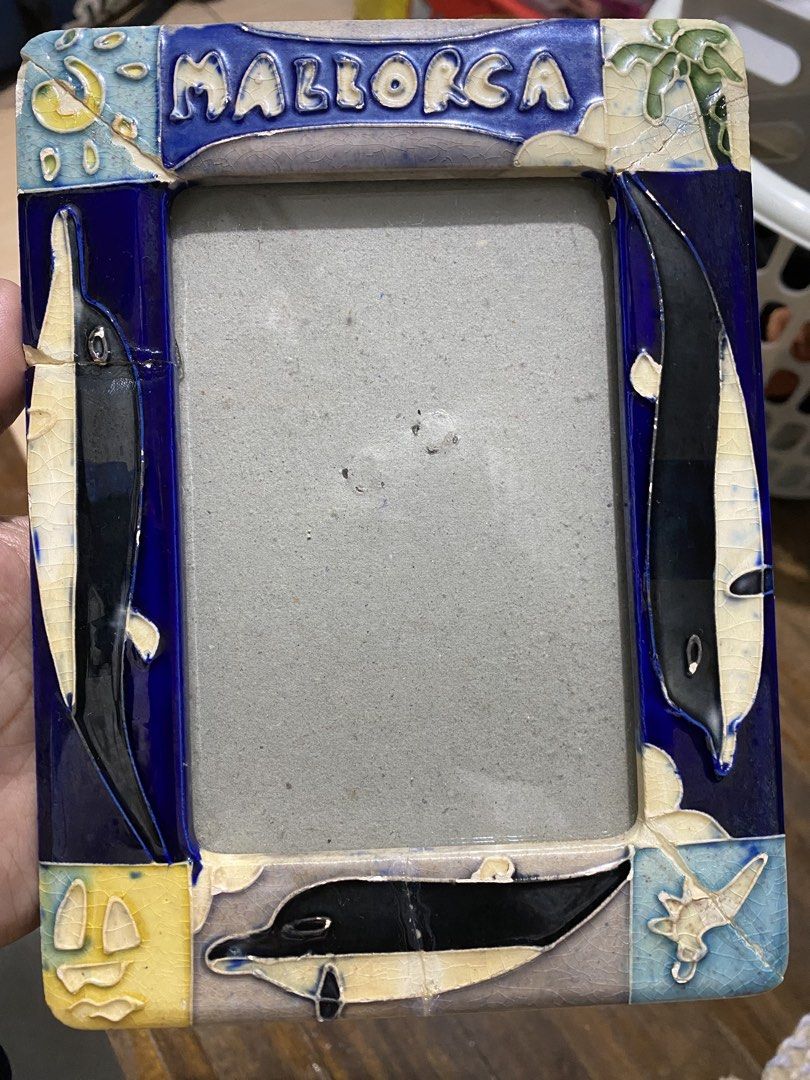 Mallorca Souvenir Frame (Category: Frames & Pictures) located in Makati City. Submitted by lasthing.22 (Listing ID 1421924496, Image 1). Description: - Mallorca souvenir frame. - Features a vibrant blue and white ceramic design. - Adorned with dolphin motifs. - Ideal for displaying photos. - A unique piece for your home. - Meetup locations available in Makati City. RFS: Declutter MOP: Gcash/Bank Transfer MOD: J&T/Lalamove.