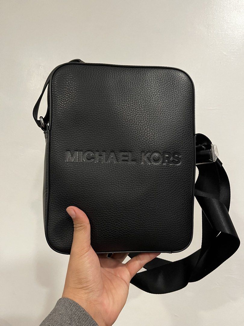Michael Kors Black Messenger Bag (Category: Luxury Bags & Wallets) located in Manila. Submitted by luxwalletbags (Listing ID 1421831361, Image 1). Description: Black Michael Kors messenger bag. Features a rectangular shape with the brand name embossed on the front. Includes a black adjustable shoulder strap. Perfect for everyday use..