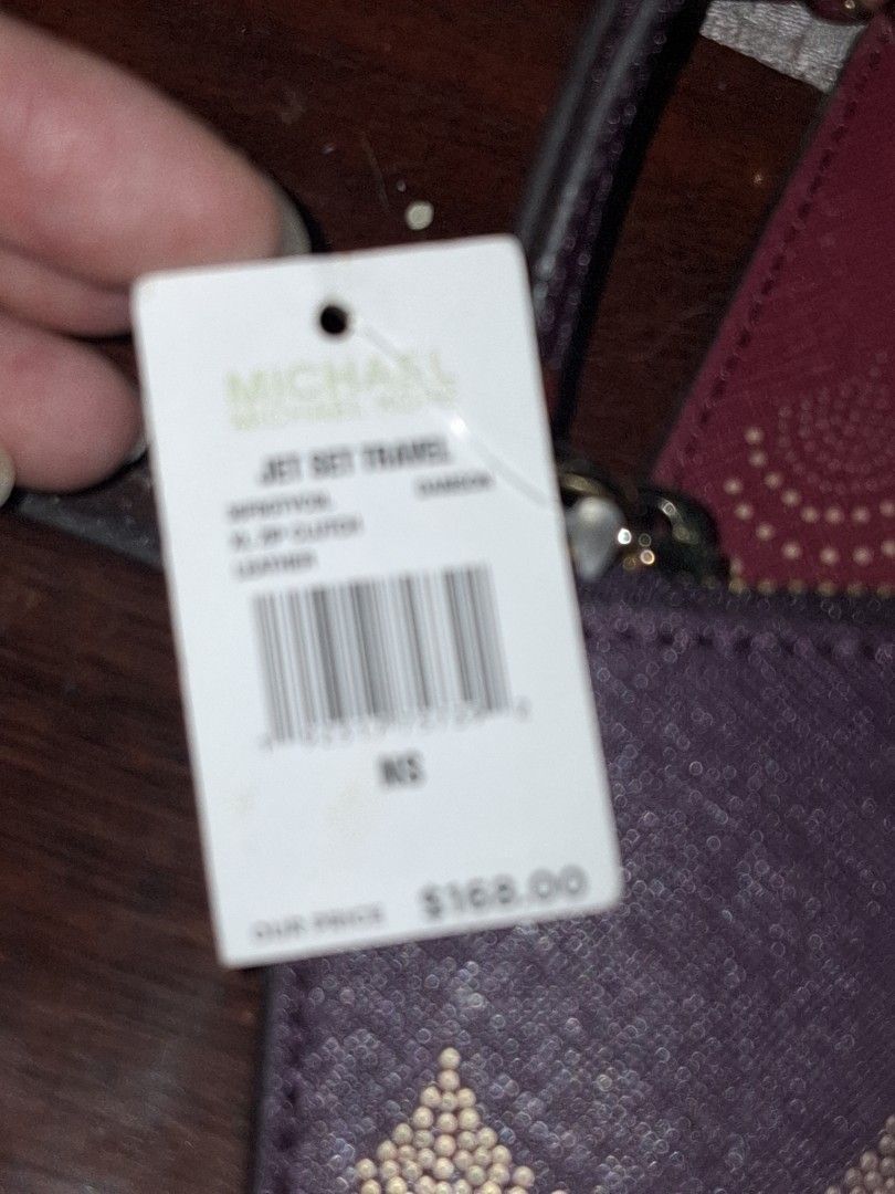 Michael Kors Clutch (Category: Clutches) located in Quezon City. Submitted by cncarousel (Listing ID 1421891743, Image 3). Description: - Michael Kors clutch in a beautiful purple color. - Features a unique patterned design. - Comes with a matching wrist strap. - Includes a Michael Kors tag and care card. - Comes with a green shopping bag. - Perfect for carrying your essentials in style..