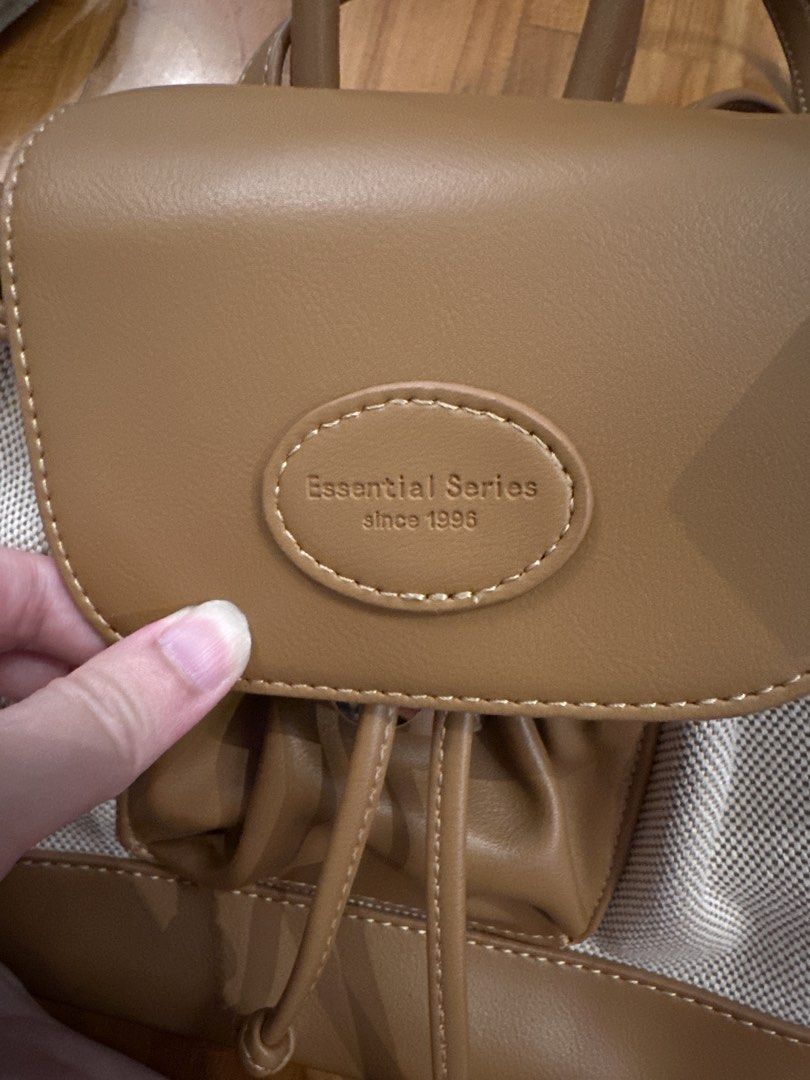 Mini Backpack with Drawstring Closure (Category: Backpacks) located in Singapore. Submitted by jrykamj (Listing ID 1421852944, Image 3). Description: - Stylish tan backpack - Drawstring and flap closure - Adjustable straps for comfort - Clean interior - Perfect for everyday use.