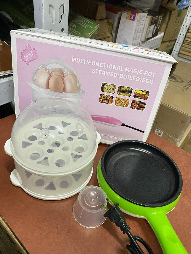 Multifunctional Magic Pot Steamed/Boiled Egg Cooker (Category: Cookers) located in Manila. Submitted by lyfrancois14 (Listing ID 1421857255, Image 3). Description: - Multifunctional magic pot for steaming and boiling eggs - Includes clear lid - Comes with egg holders - Features a small measuring cup - Includes a small frying pan attachment - Stylish green and white design with a pink handle - Ideal for quick and easy egg preparation.