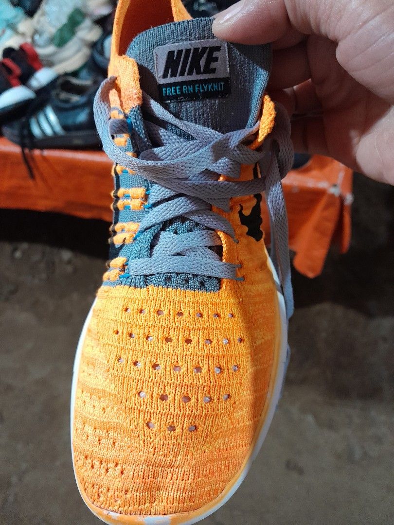 Nike Free RN Flyknit Orange Sneakers (Category: Sneakers) located in Molave. Submitted by nel95 (Listing ID 1421860934, Image 3). Description: - Nike Free RN Flyknit sneakers - Color: Orange - Features grey laces and white sole - Size: US 6, UK 3.5, EUR 36.5, 23 cm - Nike logo visible - Made in China.