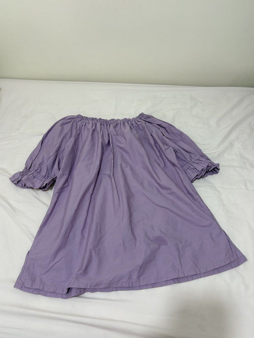 Off-Shoulder Blouse - Lavender (Category: Blouses) located in Baguio. Submitted by declutterbyshy (Listing ID 1421930608, Image 1). Description: - Off-shoulder design - Light lavender fabric - Relaxed fit - Short sleeves with ruffled cuffs - Gathered neckline - Perfect for casual wear.