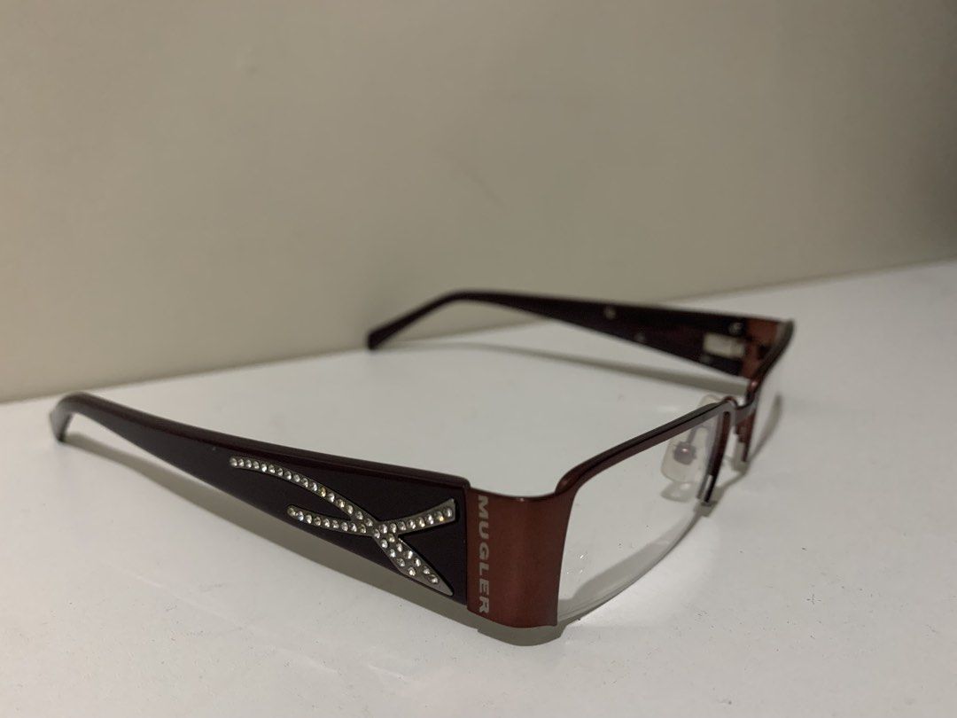 [RUSH] Original Thierry Mugler Bayonetta Eyeglasses (Dark Red) (Category: Sunglasses & Eyewear) located in San Mateo. Submitted by bluhydrangea (Listing ID 1421934656, Image 1). Description: PRICE LOWERED RUSH Thierry Mugler Bayonetta eyeglasses Dark red frame with Y2K crystal embellishments Mugler logo visible Like new condition No grade, changeable lenses.