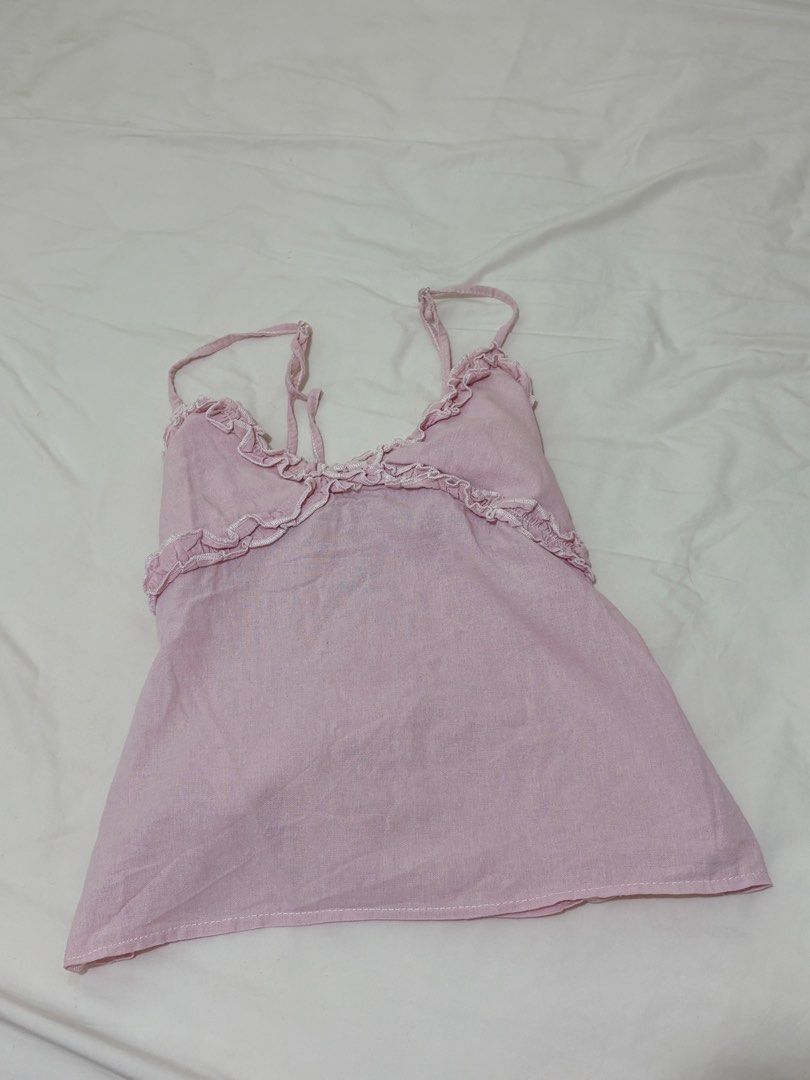 Pink Ruffled Cami Top (Category: Sleeveless) located in Baguio. Submitted by declutterbyshy (Listing ID 1421930682, Image 1). Description: - Soft pink cami top - Delicate ruffled neckline - Thin straps - Slightly flared shape - Lightweight fabric - Ideal for warm weather.