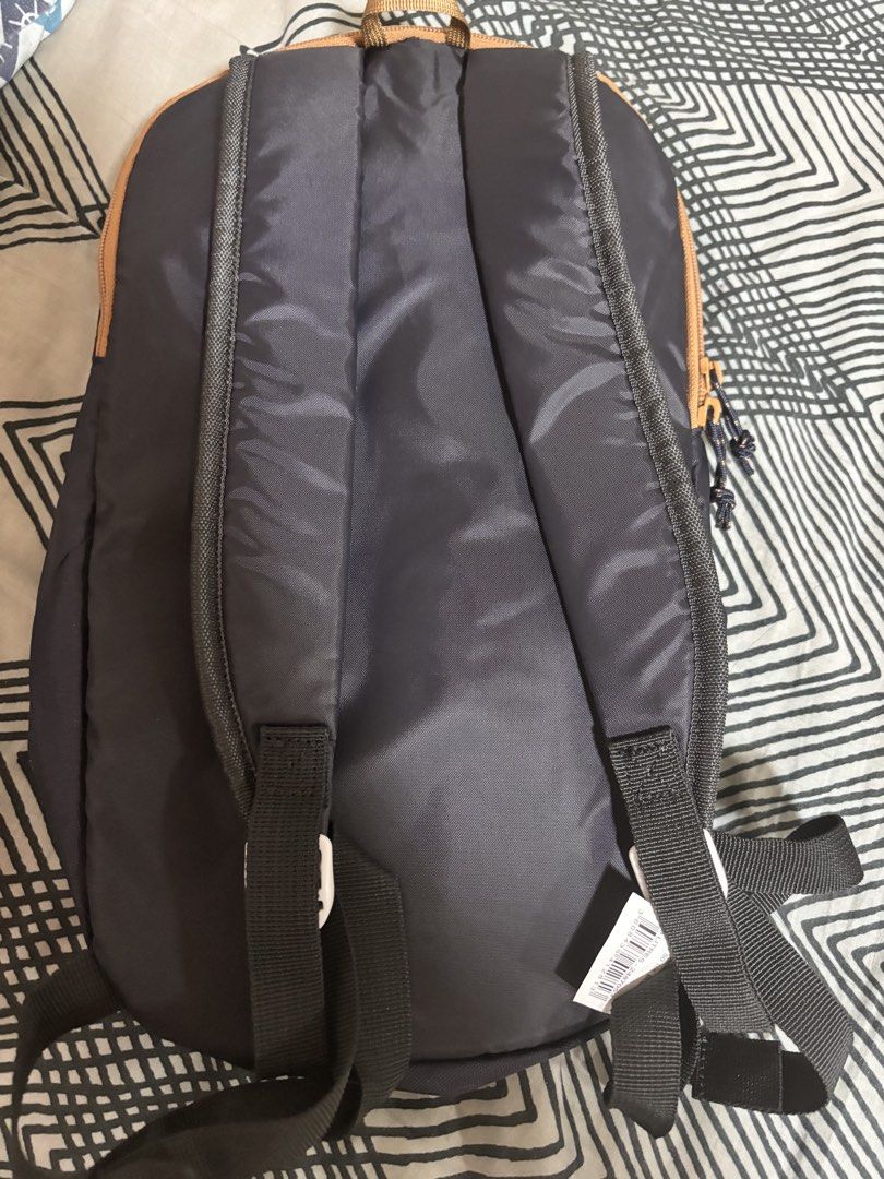 Quechua Backpack (Category: Backpacks) located in Manila. Submitted by sarahgabr03863 (Listing ID 1421812902, Image 2). Description: - Quechua backpack - Dark grey color with tan trim - Zippered main compartment - Front pocket - Adjustable shoulder straps - Lightweight design - Suitable for everyday use and light travel.
