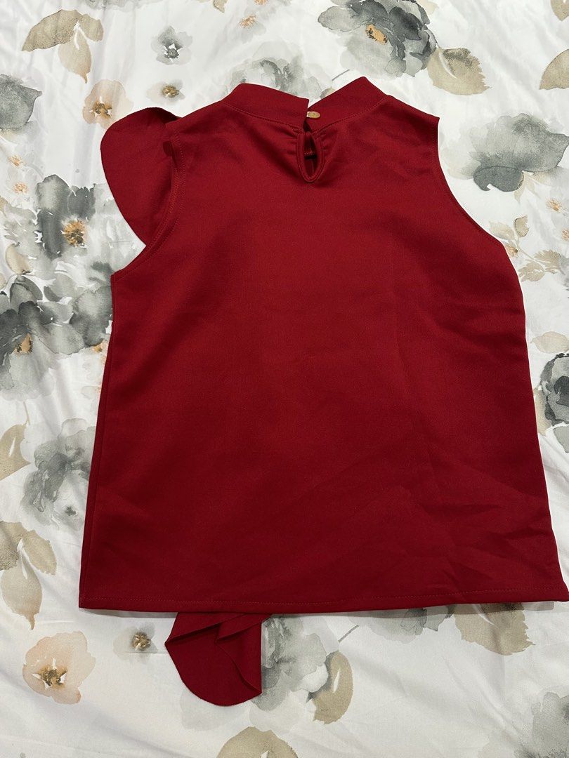 Red Sleeveless Top with Ruffle Detail (Category: Sleeveless) located in Quezon City. Submitted by timelessfinds (Listing ID 1421861098, Image 2). Description: - Red sleeveless top - Ruffle detail on front - Mock neck - Keyhole back with button closure - Smooth, woven fabric - Dress up or down.