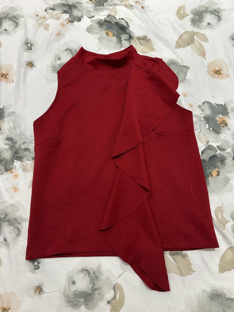 Red Sleeveless Top with Ruffle Detail (Category: Sleeveless) located in Quezon City. Submitted by timelessfinds (Listing ID 1421861098, Image 1). Description: - Red sleeveless top - Ruffle detail on front - Mock neck - Keyhole back with button closure - Smooth, woven fabric - Dress up or down.