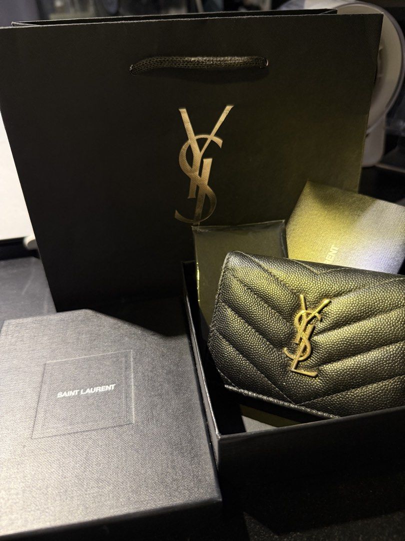 Saint Laurent YSL Wallet (Category: Luxury Bags & Wallets) located in Capas. Submitted by silvertiger_130b66 (Listing ID 1421801820, Image 1). Description: Authentic Saint Laurent wallet. Features a black quilted leather exterior with the iconic YSL logo. Includes the original box, dust bag, and shopping bag. The interior has multiple card slots and a coin compartment. RUSH SALE.