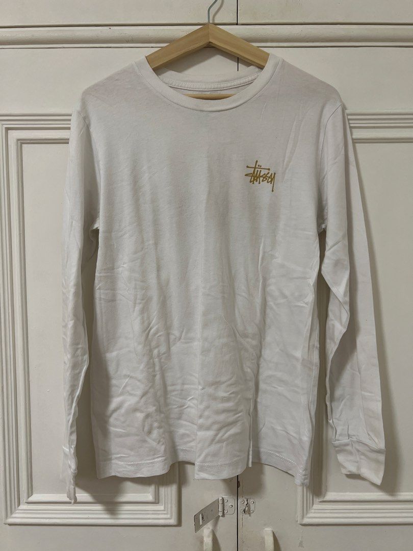 Stussy Long Sleeve Shirt (Category: Tshirts & Polo Shirts ) located in Makati City. Submitted by clothesfrombel (Listing ID 1421811973, Image 1). Description: - Stussy long sleeve shirt - Thin material, can be used as an undershirt also - Features Stussy logo (front and back) - Size: M - Crew neck - Long sleeves - good condition, see close up for minor stains pit to pit: 19” length: 25” sleeves: 23”.