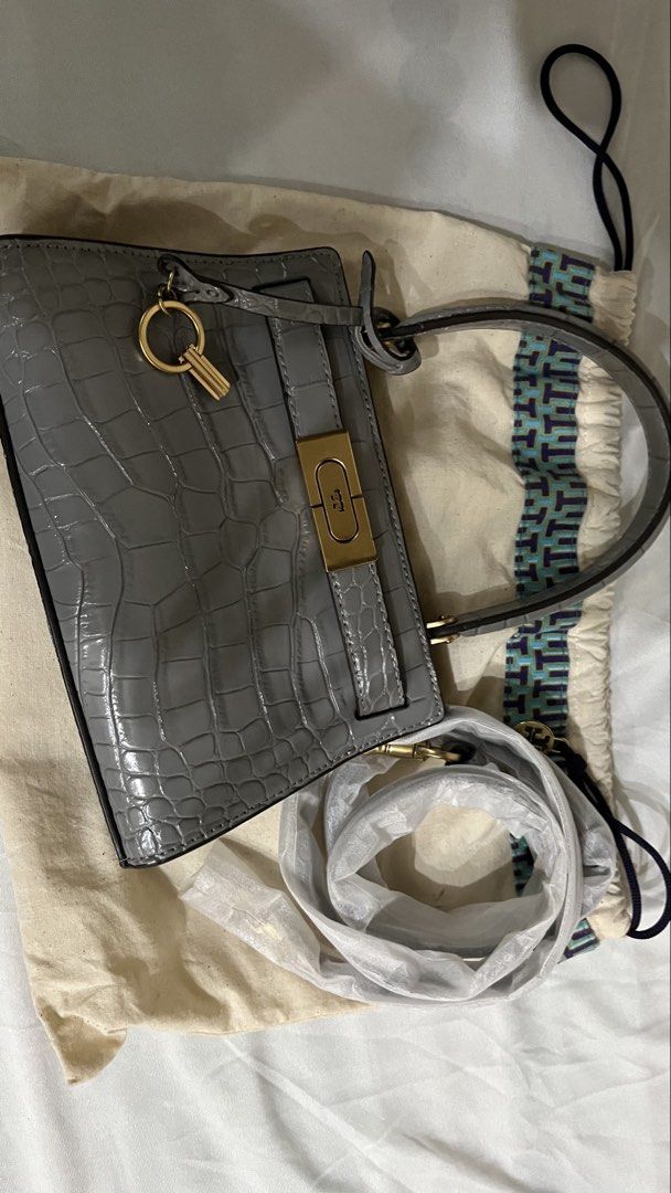 Tory Burch Lee Radziwill Shoulder Bag (Category: Luxury Bags & Wallets) located in Quezon City. Submitted by ___r. (Listing ID 1421805868, Image 1). Description: - Tory Burch Lee Radziwill Shoulder Bag - Color: Grey - Exterior: Croc-embossed leather - Features: Top handle, detachable crossbody strap - Hardware: Signature lock-and-key - Interior: Card slot - Includes: Dust bag - Design: Structured silhouette.