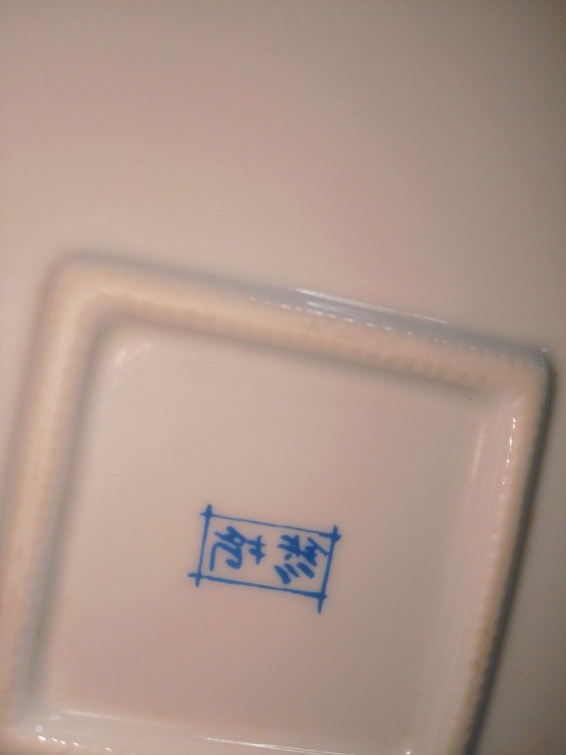 Vintage Floral Square Serving Dish (Category: Dinnerware & Cutlery) located in Cabanatuan. Submitted by miss.maia (Listing ID 1421853962, Image 3). Description: - Square serving dish - Floral design: white base with orange and blue flowers, green leaves, and gold trim - Dimensions: 20cm x 20cm - Features a blue stamp on the bottom.