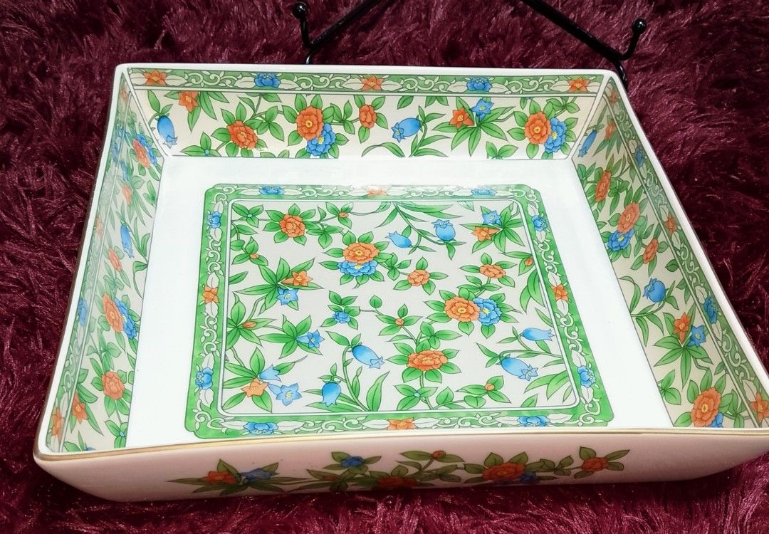 Vintage Floral Square Serving Dish (Category: Dinnerware & Cutlery) located in Cabanatuan. Submitted by miss.maia (Listing ID 1421853962, Image 1). Description: - Square serving dish - Floral design: white base with orange and blue flowers, green leaves, and gold trim - Dimensions: 20cm x 20cm - Features a blue stamp on the bottom.