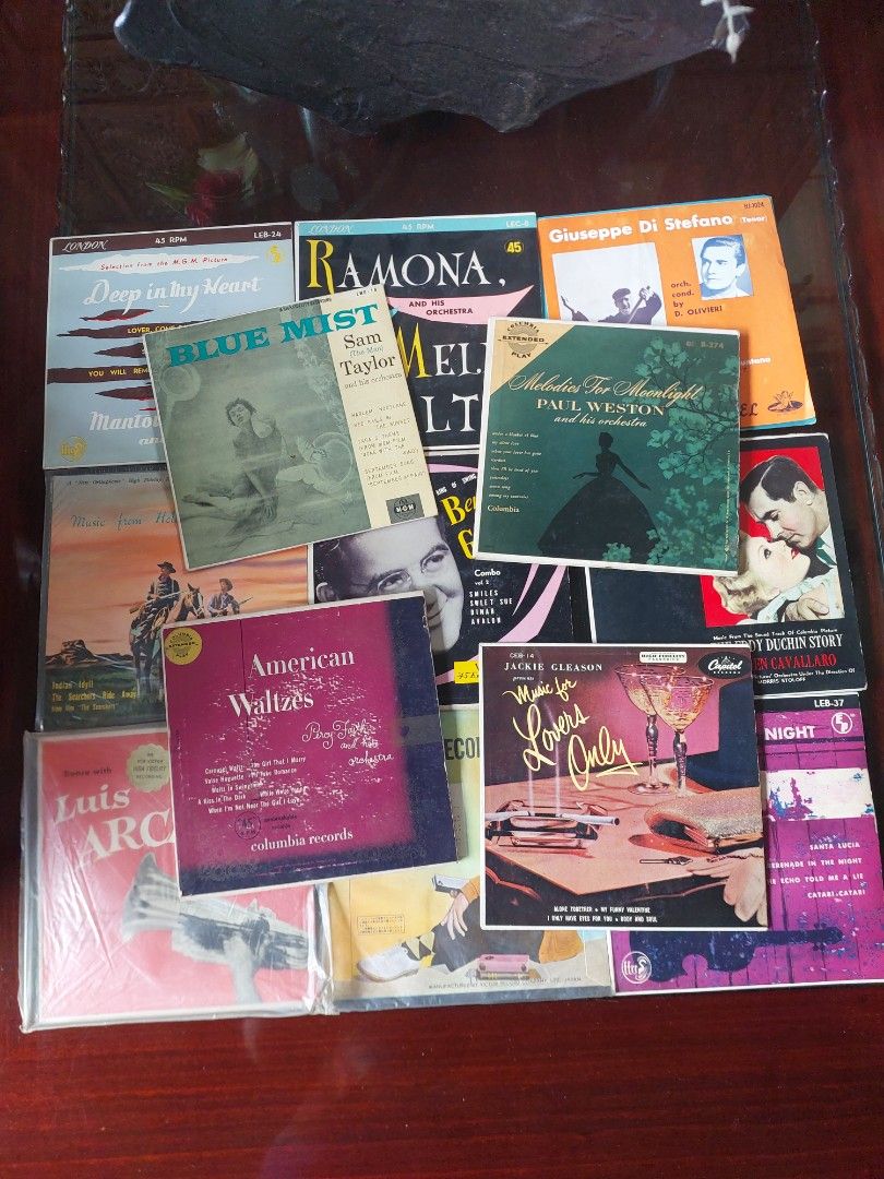 Vintage Vinyl Record Collection (Category: Vinyls) located in Bulacan. Submitted by hnbfinds (Listing ID 1421818448, Image 1). Description: Take all A collection of vintage music items features several 45 RPM vinyl records, which are collectible items popular in the mid-20th century. Artists: The collection includes records by Benny Goodman, a renowned jazz musician, and Mantovani, a popular easy-listening orchestra conductor. Content: The record