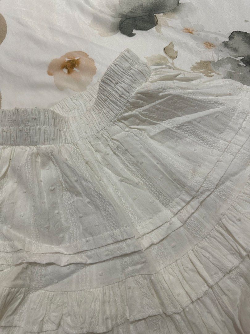 White Tiered Skirt with shorts (Category: Skirts) located in Quezon City. Submitted by timelessfinds (Listing ID 1421861232, Image 3). Description: - White tiered skirt - Elastic waistband - Textured fabric with dotted pattern - Includes inner lining - Ruffled hemline - Perfect for casual wear.