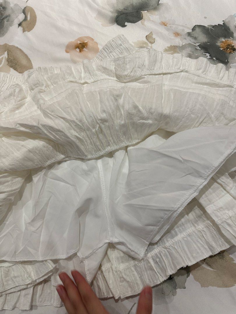 White Tiered Skirt with shorts (Category: Skirts) located in Quezon City. Submitted by timelessfinds (Listing ID 1421861232, Image 2). Description: - White tiered skirt - Elastic waistband - Textured fabric with dotted pattern - Includes inner lining - Ruffled hemline - Perfect for casual wear.