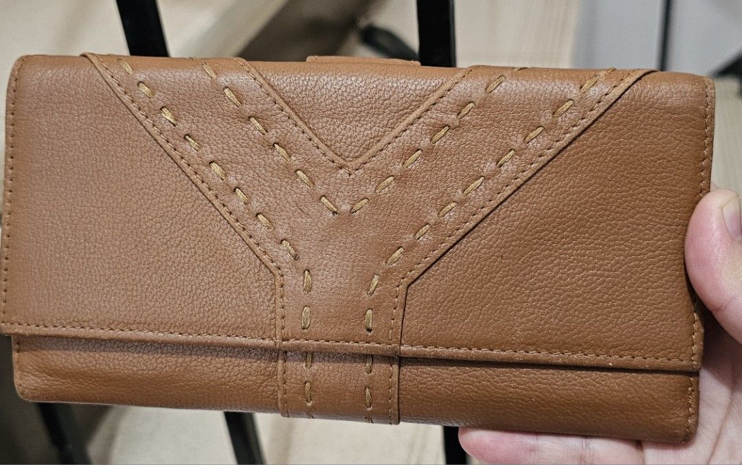 YSL Brown Leather Wallet (Category: Luxury Bags & Wallets) located in Antipolo. Submitted by jlaur26 (Listing ID 1421858764, Image 1). Description: - Vintage classic brown leather long YSL wallet - Stitched Y design on the front - Multiple card slots - Snap closure - Interior: Brown leather with YSL logo - Flap closure with snap button - price is negotiable rfs: decluttering. delivery fee to be shouldered by buyer..