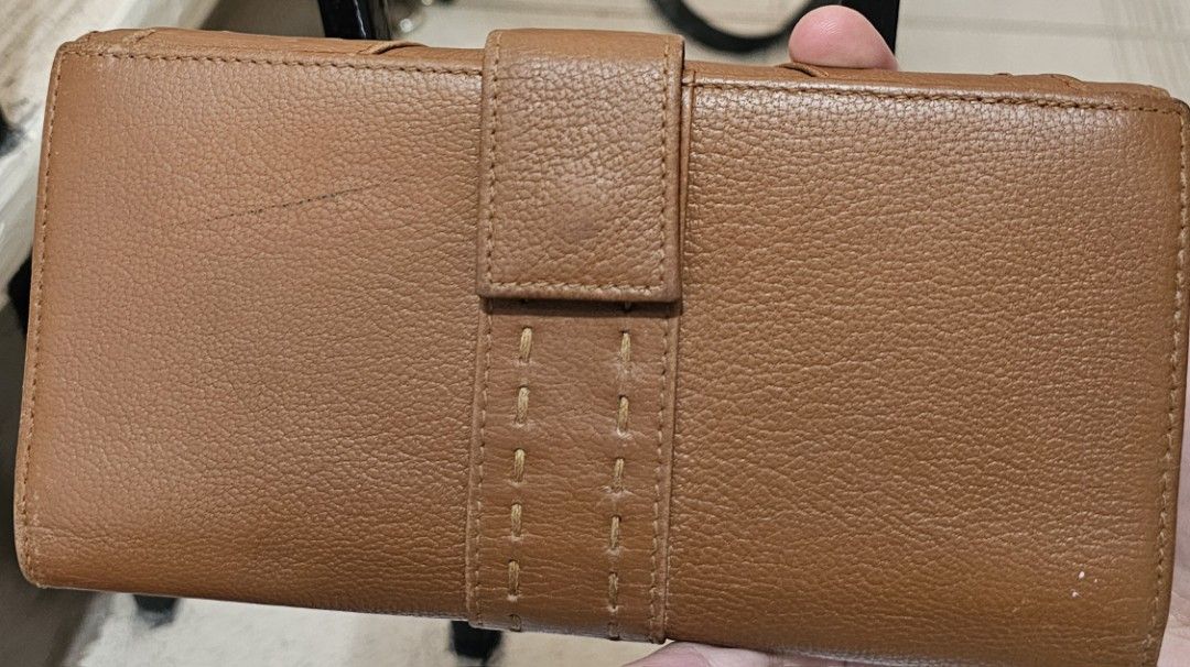 YSL Brown Leather Wallet (Category: Luxury Bags & Wallets) located in Antipolo. Submitted by jlaur26 (Listing ID 1421858764, Image 2). Description: - Vintage classic brown leather long YSL wallet - Stitched Y design on the front - Multiple card slots - Snap closure - Interior: Brown leather with YSL logo - Flap closure with snap button - price is negotiable rfs: decluttering. delivery fee to be shouldered by buyer..