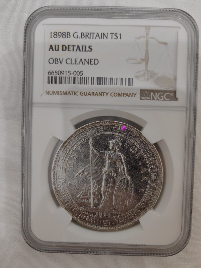 1898B G. Britain TS$1 Coin (Category: Currency) located in Davao. Submitted by ee2006 (Listing ID 1422021554, Image 1). Description: 1898B G. Britain TS$1 coin, graded by Numismatic Guaranty Company (NGC). The coin has AU Details and is OBV Cleaned. The NGC certification number is 6650915-005. The coin is encased in a protective holder..