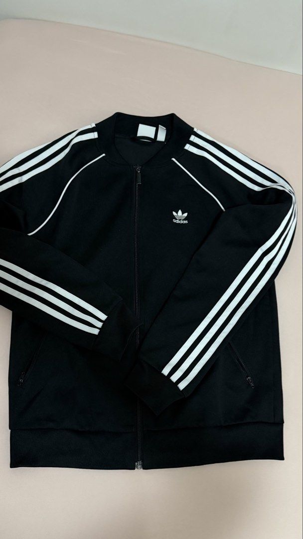 Adidas Tracksuit Black with White Stripes (Category: Activewear) located in Pasig City. Submitted by mphg37 (Listing ID 1422048718, Image 2). Description: - Adidas tracksuit - Color: Black with white stripes - Includes: Zip-up jacket and pants - Jacket features Adidas logo and three stripes - Pants feature Adidas logo, three stripes, and zippered pockets - Jacket size: US 4 - Pants size: US XS.