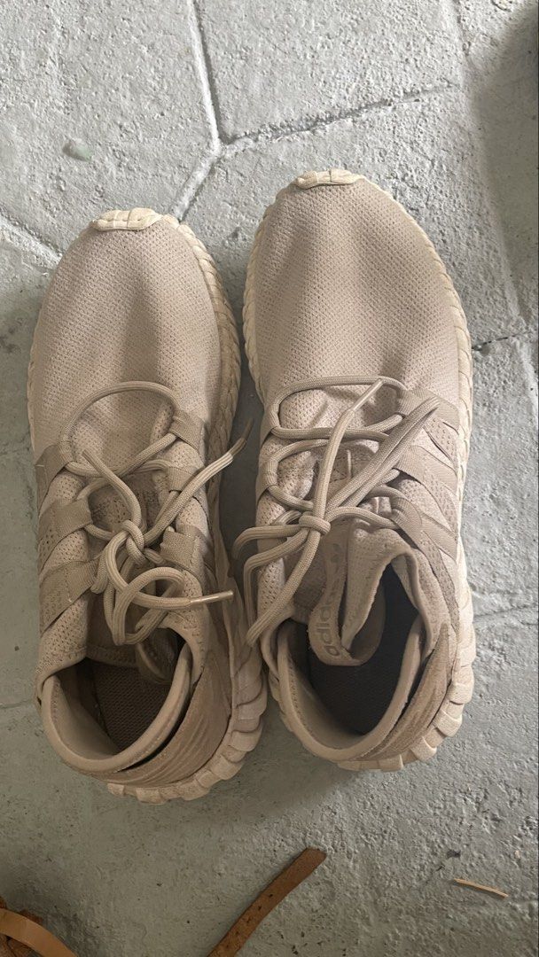 Auth Adidas Tubular Doom Sneakers (Category: Sneakers) located in General Trias. Submitted by csrtechsol61982 (Listing ID 1421982106, Image 1). Description: - Adidas Tubular Doom sneakers - Neutral beige color - Adidas logo on tongue - Signs of wear on soles - Unique ribbed design - Intact laces - Sporty and modern style.