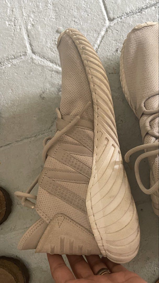Auth Adidas Tubular Doom Sneakers (Category: Sneakers) located in General Trias. Submitted by csrtechsol61982 (Listing ID 1421982106, Image 2). Description: - Adidas Tubular Doom sneakers - Neutral beige color - Adidas logo on tongue - Signs of wear on soles - Unique ribbed design - Intact laces - Sporty and modern style.