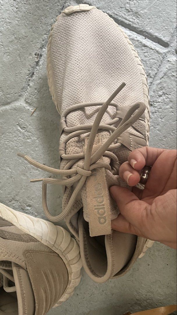 Auth Adidas Tubular Doom Sneakers (Category: Sneakers) located in General Trias. Submitted by csrtechsol61982 (Listing ID 1421982106, Image 3). Description: - Adidas Tubular Doom sneakers - Neutral beige color - Adidas logo on tongue - Signs of wear on soles - Unique ribbed design - Intact laces - Sporty and modern style.