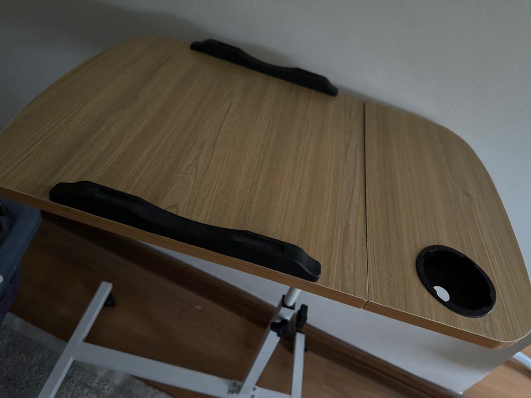 Adjustable Height Bedside Table (Category: Tables & Sets) located in Shah Alam. Submitted by rarebird.b4a092 (Listing ID 1422017871, Image 3). Description: - Adjustable height & foldable design - Made of pro-wooden material - Size: (40+20)*40 - Includes a cup holder - Dedicated section for laptop or tablet - Mounted on wheels for easy mobility.