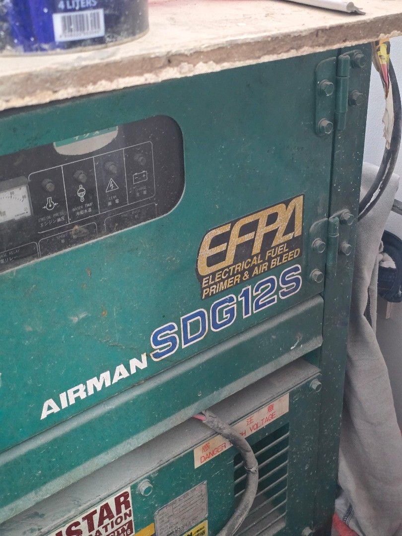 Airman Generator (Category: Construction Tools & Equipment) located in Pasig City. Submitted by doubleyami (Listing ID 1422042658, Image 2). Description: - Airman generator - Barely used - Green exterior with Airman logo - Features a control panel, ports, and cables - Heavy-duty model - Suitable for residential & small commercial - Mounted on a base with legs for stability.