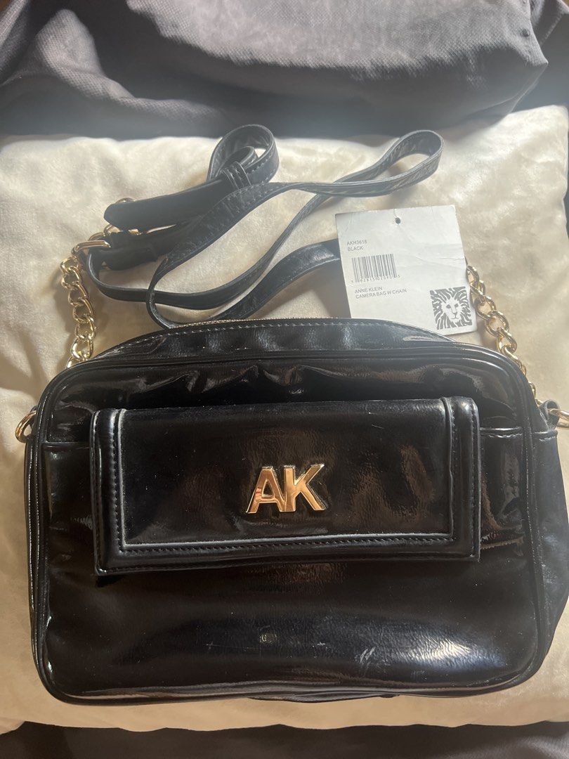 Anne Klein Black Crossbody Bag (Category: Cross-body Bags) located in Taguig. Submitted by stuffitlikeitshot (Listing ID 1421956717, Image 1). Description: - Black Anne Klein crossbody bag - Gold-tone hardware - Front pocket with "AK" logo - Chain strap- adjustable - Zipper closure - Patent leather material - used a few times only.