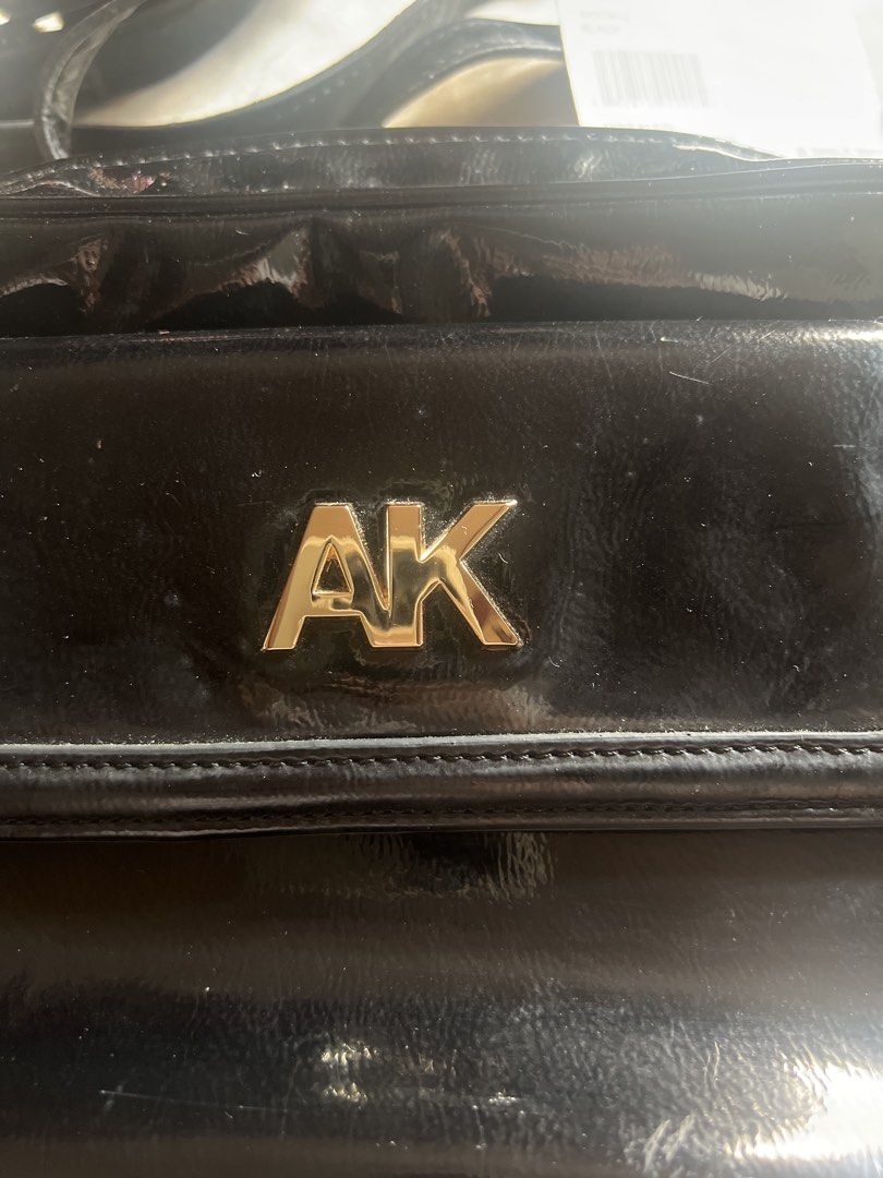 Anne Klein Black Crossbody Bag (Category: Cross-body Bags) located in Taguig. Submitted by stuffitlikeitshot (Listing ID 1421956717, Image 2). Description: - Black Anne Klein crossbody bag - Gold-tone hardware - Front pocket with "AK" logo - Chain strap- adjustable - Zipper closure - Patent leather material - used a few times only.