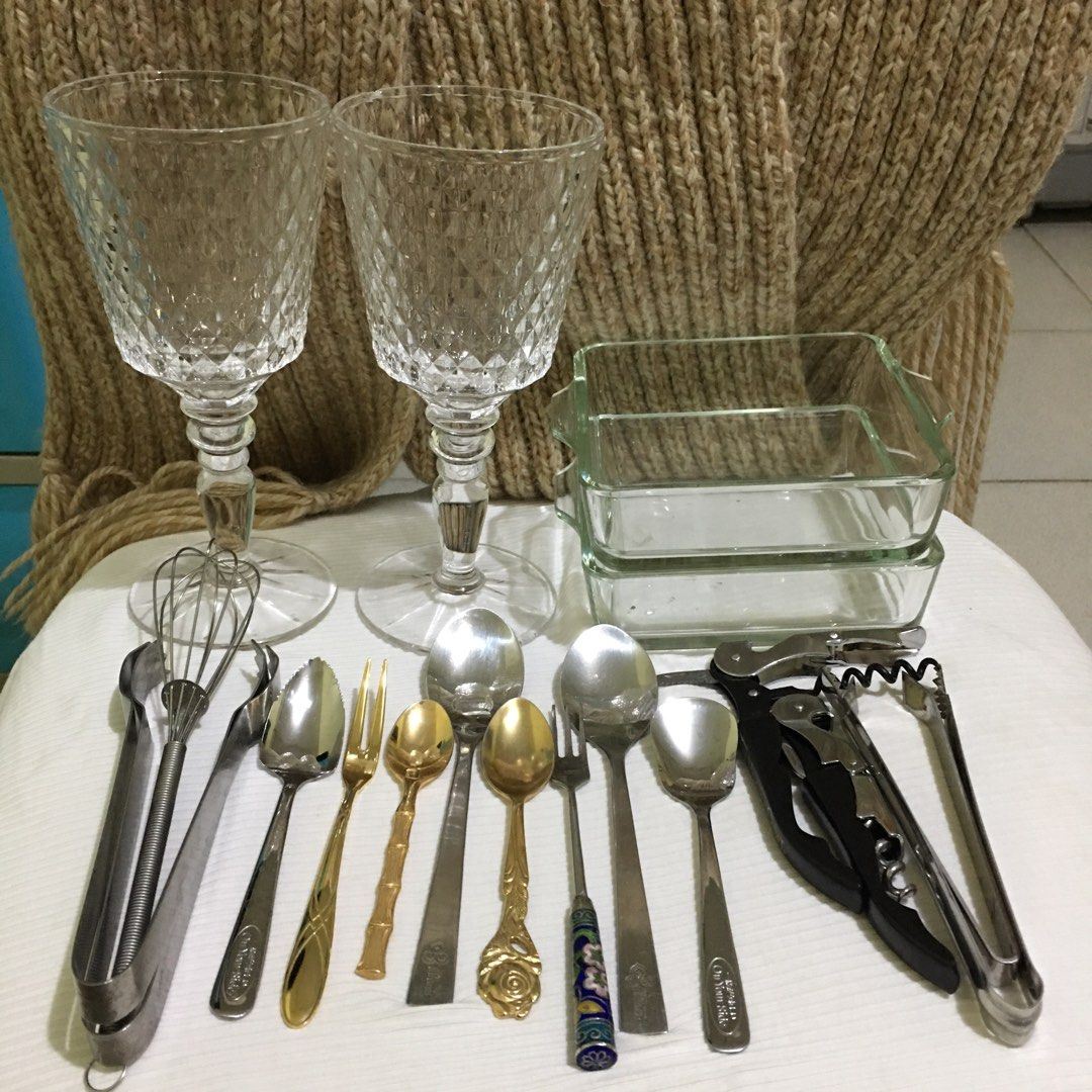 Assorted Kitchen Utensils and Glassware (Category: Other Kitchenware & Tableware) located in Makati City. Submitted by tasteofluxury (Listing ID 1422046916, Image 1). Description: Set includes two wine glasses, two glass baking dishes, various spoons, forks, and serving tongs. Also included are two corkscrews and a whisk. The spoons have different designs with brand, including a bamboo-style and a rose-detailed spoon. The set is perfect for servi