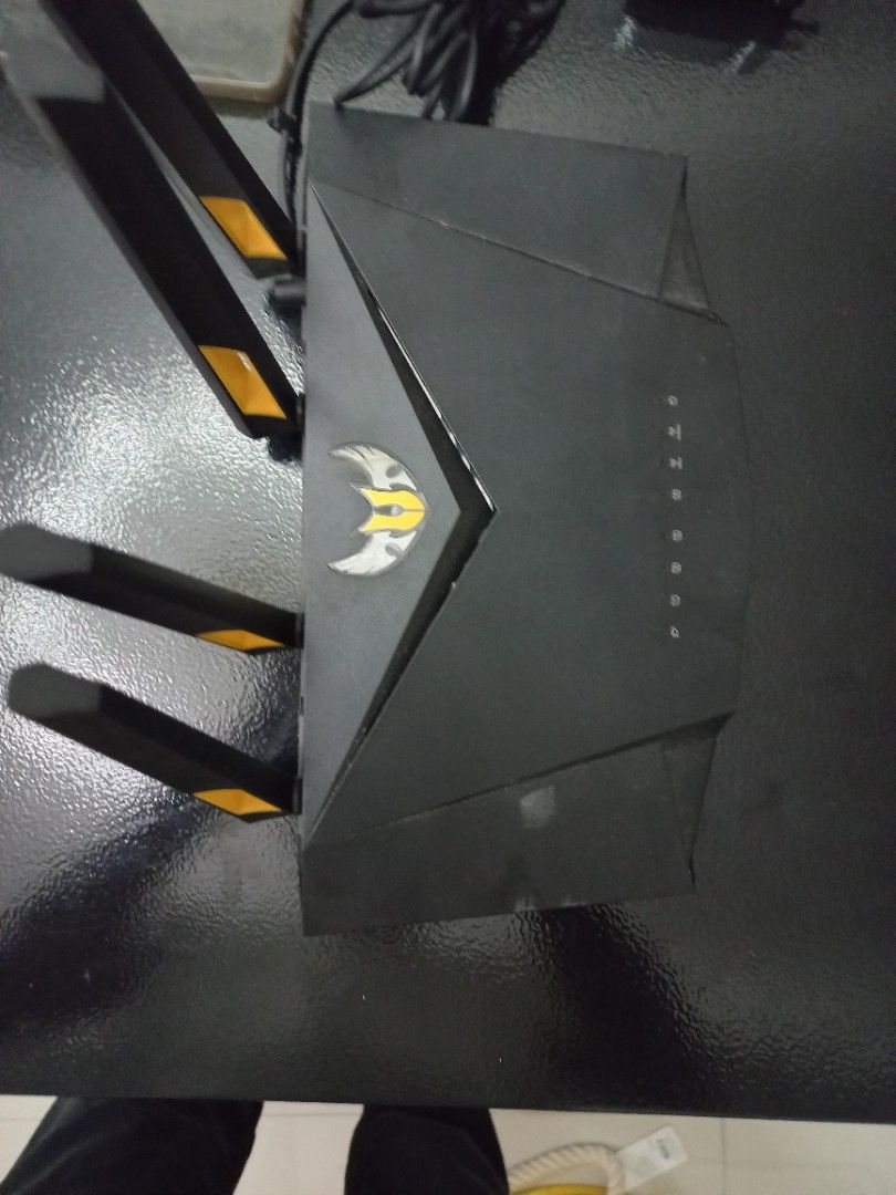 ASUS Dual Band WiFi Router (Category: Networking) located in Makati City. Submitted by zencrystal-3de6cc (Listing ID 1422070172, Image 1). Description: ASUS Dual Band WiFi Router with multiple antennas. Features several ports at the back. Includes a power adapter. The router has a black finish with a distinctive design. The model number is RT-AX86U. The router has a distinctive design with multiple antennas..