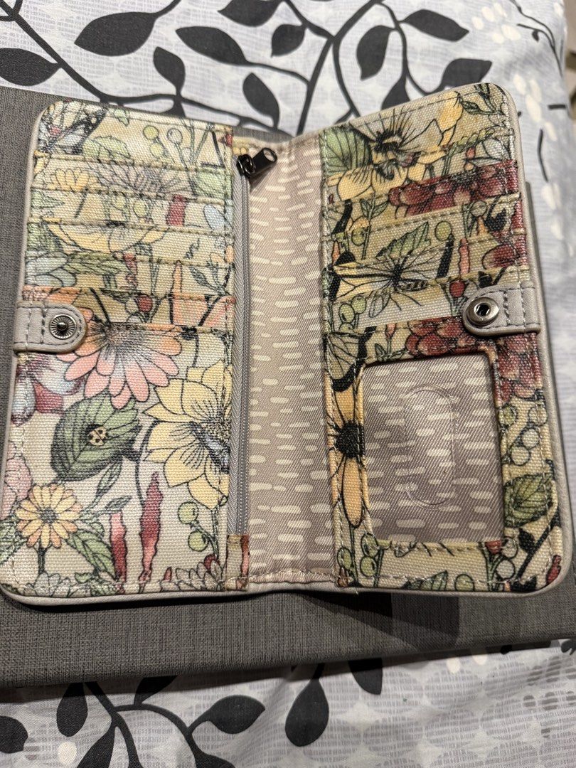 Authentic Sakroots Floral Print Wallet (Category: Wallets & Card holders) located in Valenzuela. Submitted by polchipreloveditems (Listing ID 1421989088, Image 3). Description: - Sakroots floral print wallet - Multiple card slots - Zippered compartment - Clear ID window - Snap closure - Zip-around design - Colorful floral exterior with butterfly accent - Neutral dotted interior lining.